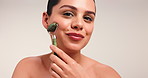 Jade roller, skincare and face of happy woman in studio for anti aging, facial massage and smooth skin. Beauty, space and portrait of person for dermatology, spa benefits or detox on white background