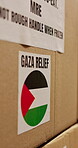 Palestine, donation and charity box with delivery for war relief, famine crisis or parcel shipping. Cargo, MRE or caution label on package for social responsibility, Gaza outreach or NGO distribution