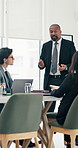 Business people, presentation and man in meeting, CEO and financial agency with motivation. Employees, speaker and mature person with company mission, conversation and review revenue with feedback