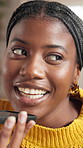 Black woman, speakerphone call and talk in home, relax or happy with chat on app in living room. African person, smartphone and smile for discussion, gossip or laugh at funny story in lounge at house