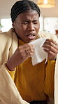Sick, blanket and woman with sneeze in tissue for respiratory illness, cold and allergy. Fever, hayfever and black person with blowing nose in home for influenza, congestion and sinusitis infection