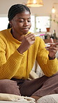 Disappointed, pregnancy test and black woman on sofa in home with stress for negative result with bad news. Anxiety, unhappy and African person with pregnant kit for ivf fail in living room at house.