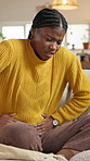 Pain, woman or stomach cramps on sofa in home for IBS disease, gastritis or uncomfortable ache. Discomfort, black person and massage belly for bladder infection, menstruation cycle and endometriosis