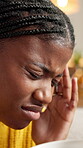 African woman, migraine and coffee at house for stress, mental health and burnout symptoms. Tired, sick and female person with herbal tea for headache, brain fog and vertigo pain with recovery drink