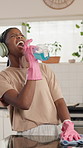 Black woman, spray bottle and singing with cleaning home, happy and laugh with headphones in kitchen. African person, voice and music with routine, streaming or ppe gloves with chemical for hygiene