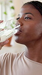 Drinking, water and woman in home, refresh and hydration with liquid, healthy or fluid in apartment. Thirsty, black person and prevention of dehydration with beverage, calm and wellness in house