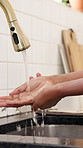 Water, washing hands and woman in kitchen in home for hygiene, wellness or health routine. Tap, sink and female person cleaning skin for removal of dirt, dust or germs with virus prevention in house.