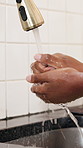 Water, washing hands and woman in kitchen in house for hygiene, wellness or health routine. Tap, sink and female person cleaning skin for removal of dirt, dust or germs with virus prevention in home.