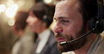Call center, night and business man with headset in office for insurance claims, help and contact. Coworking, talking and worker on computer for customer service, financial advice and online support