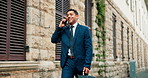 Phone call, business man and walking in city for travel, property negotiation or offer. Mobile, real estate agent and communication outdoor for commute, development opportunity and talk to contact