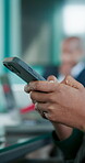 Hands, person and texting in office with phone, notifications and scrolling for updates. People, online messaging or typing in company with technology, connection or digital app for communication