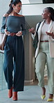 Smile, communication and walk with business women in convention center for conference, seminar or tradeshow. People, low angle and chat with employee discussion in lobby for event, expo or symposium