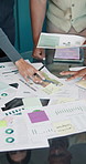 Business people, hands and planning with documents, chart or product selling report for investment. Team, paper and graph in meeting for sales discussion, financial review or data analysis in office