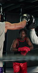 Fitness, pads or sports with boxer and personal trainer in gym for improvement or training. Exercise, power or technique with athlete and coaching in boxing ring together for intense workout