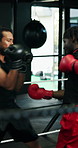 Boxing, fight and men in gym with gloves, preparation and training together for competition. Motivation, sport and fitness coach in studio with ring, speed and fighting skill in impact sports.