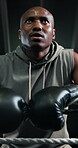 Boxer, man and tired with breathing at gym for fight challenge, intense training and recovery. Combat sports, black person and exhausted in boxing ring for match performance, sweating and low angle