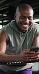 Phone, fitness and black man in gym for boxing training with networking, social media or communication. Happy, practice and male athlete with cellphone for online text on mobile app in sports center.