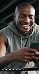 Cellphone, fitness and black man in gym for boxing training with networking, social media or communication. Happy, practice and male athlete with phone for online text on mobile app in sports center.