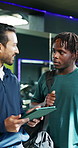 Gym tour, information and tablet with men in conversation for membership, sign up or subscription. App, exercise or schedule with client and manager talking in health club for fitness or training