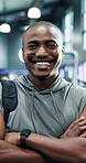 Arms crossed, face and fitness with black man in gym for development or workout as personal trainer. Exercise, happy and laughing with funny African coach in health club for improvement or training