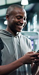 Fitness, phone and man laugh in gym for meme, joke and check schedule on internet. Mobile, sports club and happy person with app for funny video, social media and communication with text message