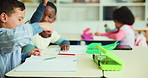 Fist bump, students and boys in classroom, education and support with growth, learning and creativity. Friends, school and kids with happiness, hand gesture and child development with project and fun