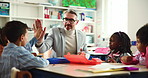 High five, motivation and man in classroom, students and support with knowledge, growth and education. Teacher, group and kids in school, achievement and child development with creativity or learning