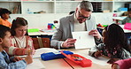 Man, teacher and children in classroom with drawing, explain and development with education at school. Mature person, kids and group with paper, sketching or creativity with learning art at academy