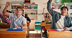 People, students and raised hand in class for question, participation and problem solving. Men, fist bump and educator attention with quiz answer, learning solution and feedback for education lesson