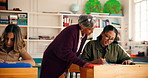 Education, teacher and advice for student, classroom or help for assignment, conversation and learn. Talking, woman and educator with learner in high school, writing and assistance for exam or info