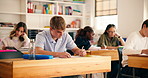 School, college and students in classroom writing for exam, test and quiz in lesson. University, academy and people with notes, books and answers for education, learning and studying for assessment