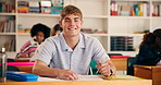 Happy, face and teenager in high school with test, exam or assessment with writing for education. Smile, learning and portrait of boy student with books for notes for studying in classroom at campus.