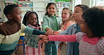 Children, friends and stack hands for learning, support and education in elementary school. Kids, celebration and happy students with teamwork, cooperation and clapping for success together in class
