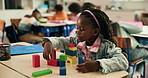 Knowledge, student and child with building blocks, classroom or creative game for fine motor skills. School, girl and pupil with cognitive development, education and problem solving with structure
