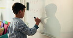 Child, student and numbers on whiteboard in class for lesson, maths answer and problem solving. Boy, kid and thinking for calculations solution, education activity and learning for knowledge growth