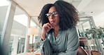 Glasses, laptop and thinking with designer woman in office for development or project management. Business, computer and planning with African employee in workplace for programming from below