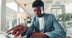 Laptop, reading and typing with designer  black man in office for development or project management. Business, computer and creative with African employee in workplace for programming from below