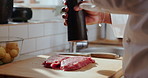 Hands, seasoning and steak with chef in kitchen of restaurant for preparation of gourmet meal. Cooking, cuisine and flavor with person making protein food for culinary dish, fine dining or recipe