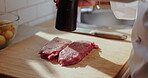 Flavor, hands and steak with chef in kitchen of restaurant for preparation of gourmet meal. Cooking, cuisine and seasoning with person making protein food for culinary dish, fine dining or recipe