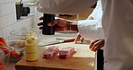 Hands, chef and seasoning steak for cooking with salt, beef or condiments for flavor. Meat, food preparation and people with spices for cuisine, culinary or catering with team in restaurant kitchen