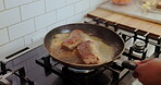Hands, chef and cooking food in pan with butter ingredient, prepare steak and searing process. Person, frying and meat with culinary technique, gourmet cuisine and enhance flavor of recipe at house