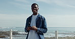Beach, face and black man with smartphone, travel and social media with summer holiday. Happy, ocean and African person with cellphone, vacation and online chatting with connection and break in Miami