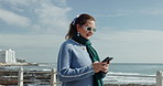 Ocean, walking and woman with smartphone, travel and vacation with connection. Shades, beach and person with cellphone, summer holiday and online chatting with communication, social media and texting
