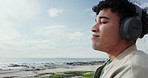 Ocean, breathing and man with headphones, vacation and listening to music, beach and peaceful. Seaside, shoreline and space with person, headset and radio with mindfulness, travel and break in Miami