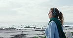 Thinking, woman and headphones at sea for travel ideas, holiday vision and listening to music. Wonder, female person and space with fresh air, streaming podcast and vacation reflection for beach trip