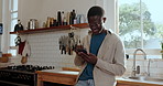 Kitchen, happy and black man with phone for typing message, online chat and social media. Home, relax and person on smartphone for internet connection, communication and networking on mobile app