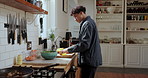 Cooking, vegetables and man in kitchen for salad, meal or food for healthy dinner in apartment. Nutrition, organic ingredients and male person preparing supper for wellness diet with produce in home.