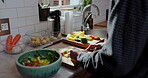 Hands, cooking and cut vegetables in home for salad recipe, culinary food or meal preparation. Nutrition, person or fresh ingredients in kitchen for vegetarian diet, vegan soup or healthy dinner dish