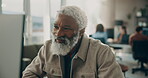 Happy, black man and reading on computer in office for research, review article and editing draft. Mature person, coworking and pc for proofreading, news feedback and story headline for publication