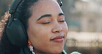 Outdoor, woman and listening to headphones, music or dancing with audio, streaming or entertainment. Calm, person and subscription for playlist, radio and tech with sound, park and break with song